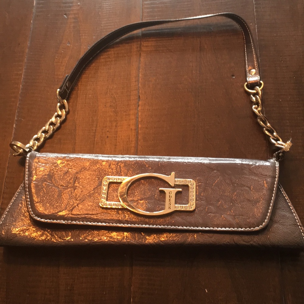 Like new GUESS clutch. Beautiful silver material!